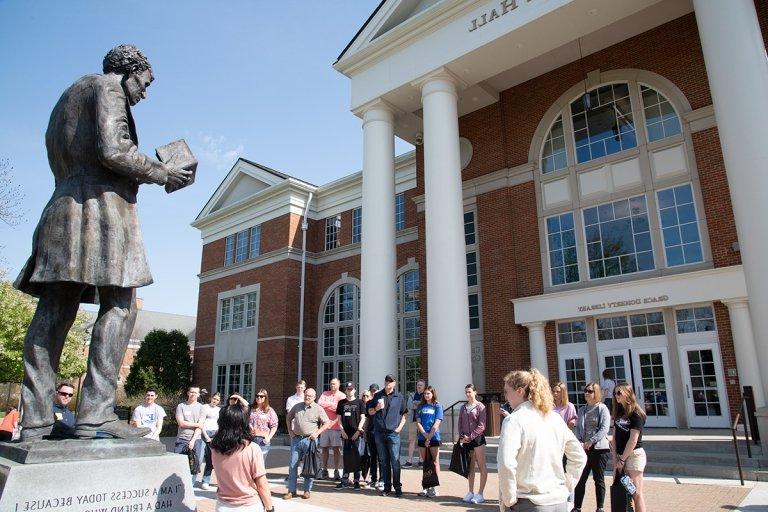 Large group of students Campus tour in front of Crounse Hall looking at Abraham Lincoln statue